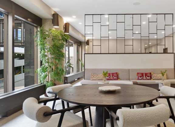 A modern dining room with a round table and chairs.