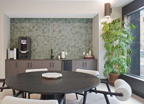 A modern dining room with a round table and chairs.
