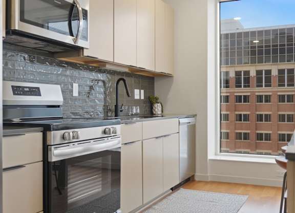 A kitchen with a stove, oven, and microwave.
