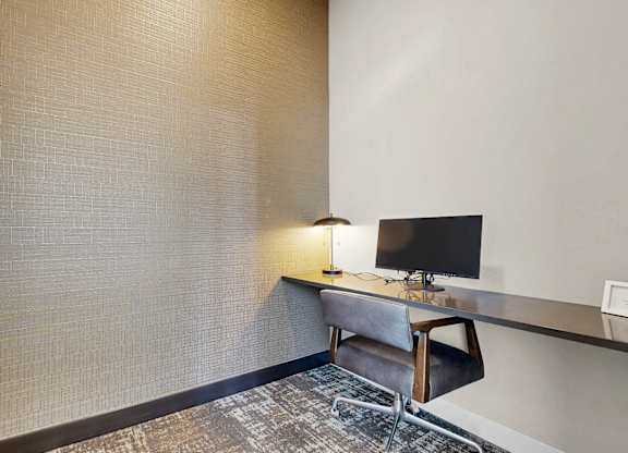 A room with a desk and a chair.