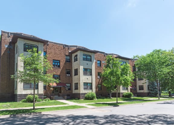 a large brick building with trees in front of it
