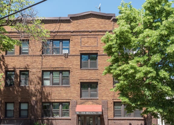 a brick building with a tree in front of it