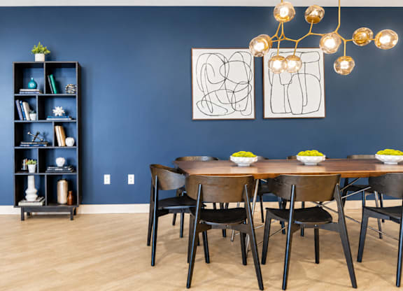 A dining room with a wooden table and chairs.