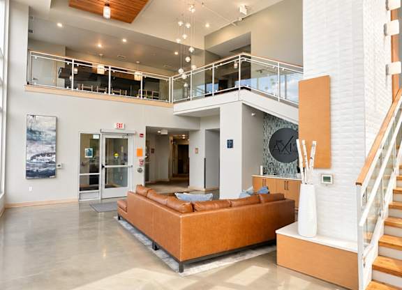 A large open living room with a staircase and a couch.