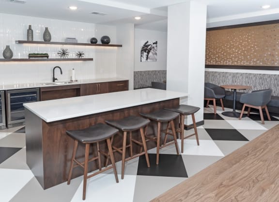 a kitchen with a white counter top and black and white tiles on the floor at The Exchange Apartments, New Brighton