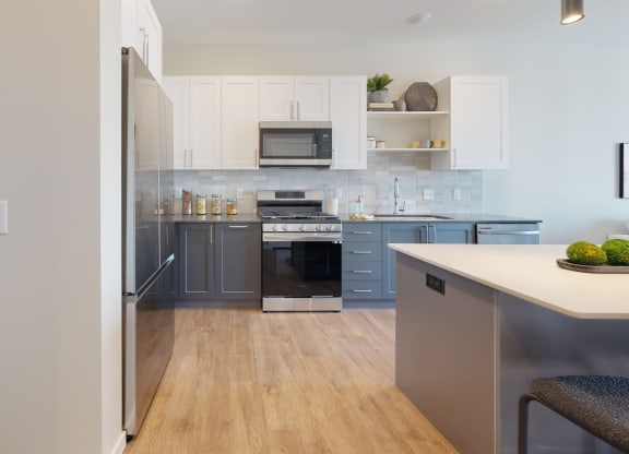 a kitchen with white cabinets at The Exchange Apartments, New Brighton, MN 55112