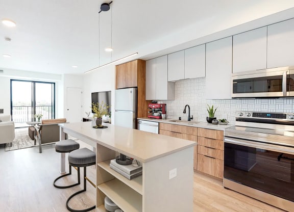 a kitchen with a large island and a living room at The Mason, St. Paul