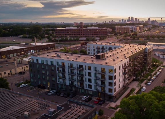an aerial view of an apartment building with a city skyline in the background at The Mason, St. Paul, MN, 55114