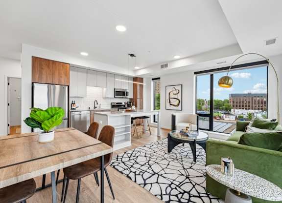 A modern kitchen with a dining table and chairs.