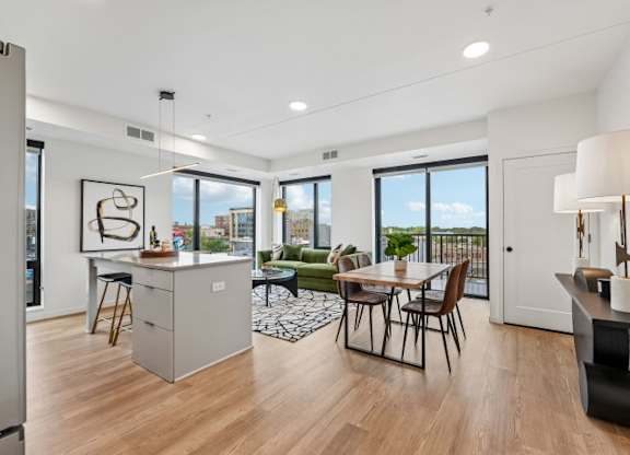 A modern kitchen with a dining table and chairs.