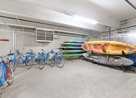 a row of bikes and kayaks in a garage