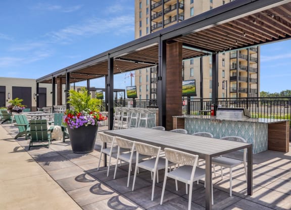 a patio with a table and chairs and a bar