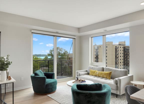 a living room with a large window and a balcony