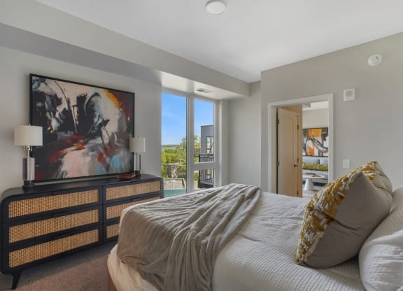 a bedroom with a large bed and a large window
