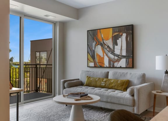 a living room with a couch a table and a window