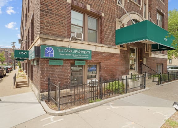 a building with a green awning and a sign that reads the park condominiums