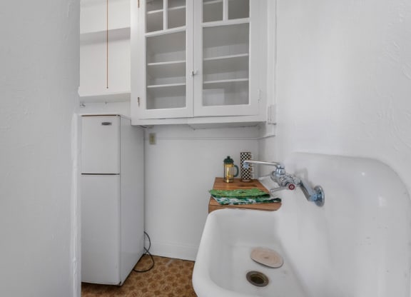 a small kitchen with a sink and a refrigerator