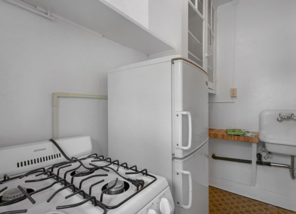 a kitchen with a stove and a refrigerator