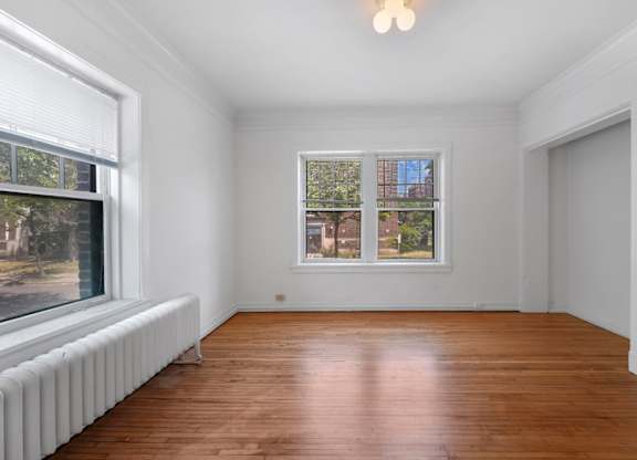 A room with a window and a radiator on the wall.
