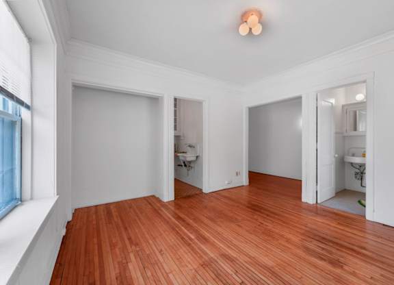 A room with wooden floors and white walls.
