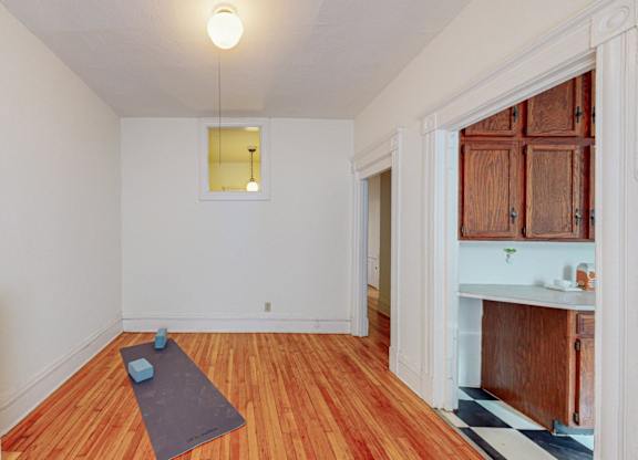 A room with a yoga mat on the floor.