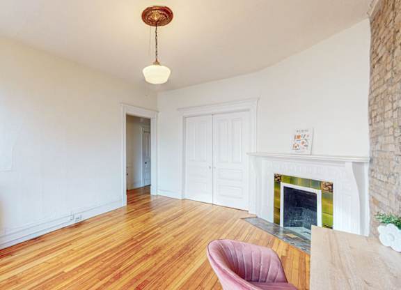 A room with a fireplace and a chair.