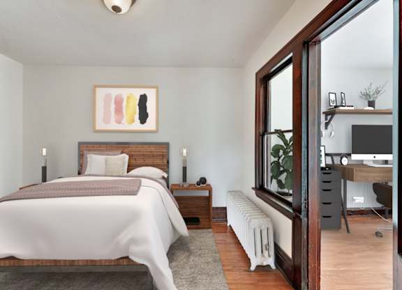 A bedroom with a large bed and a painting above it.
