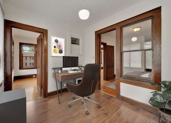 A room with a desk and a chair.
