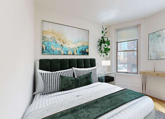 A bedroom with a large bed and two paintings on the wall.