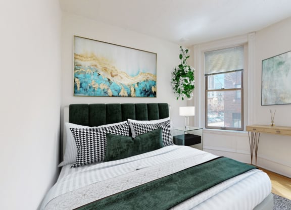 a bedroom with a bed and two windows