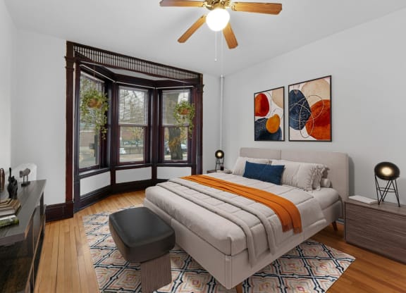 a bedroom with a bed and a large window