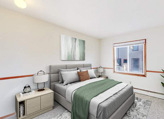 A bedroom with a bed, nightstand, and a window.