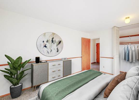 A bedroom with a bed, a couch, and a wardrobe.