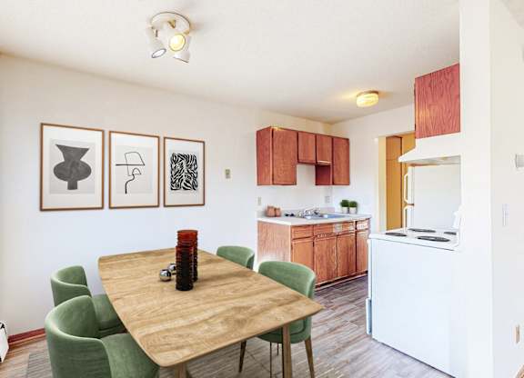 A dining room with a wooden table and green chairs.