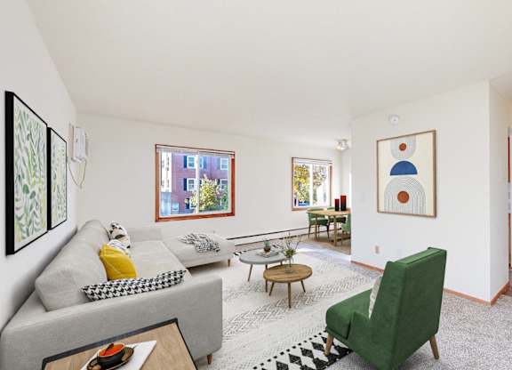 A living room with a grey couch, a green chair, and a coffee table.
