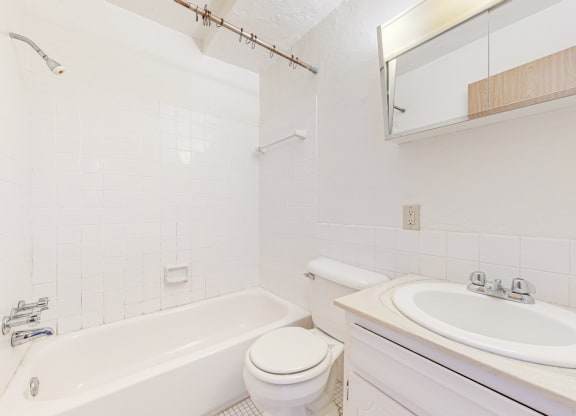 a bathroom with a sink toilet and bathtub