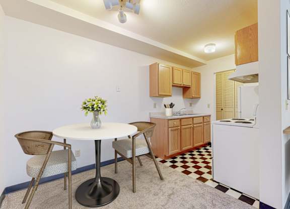 A kitchen with a table and chairs in the middle of the room.