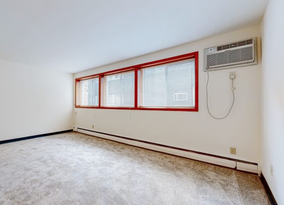 a bedroom with white walls and carpet