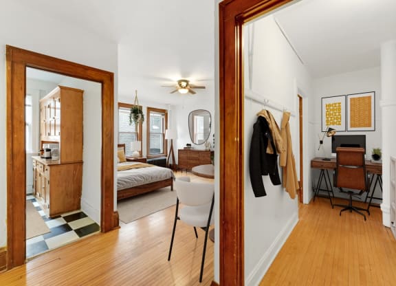 a living room with a mirror and a bedroom with a bed