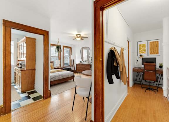A bedroom with a bed, desk, and chair.