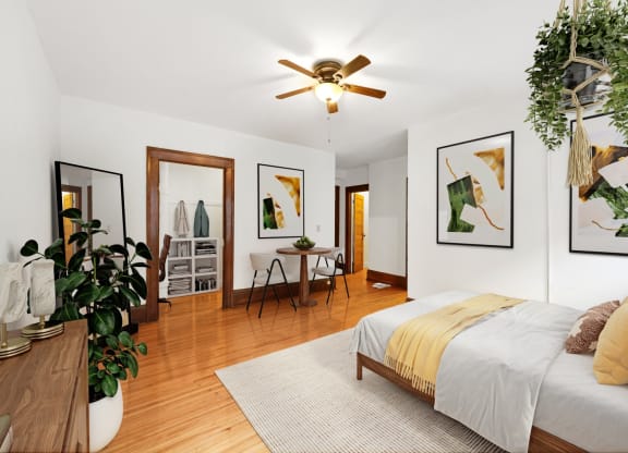 a bedroom with a bed and a ceiling fan