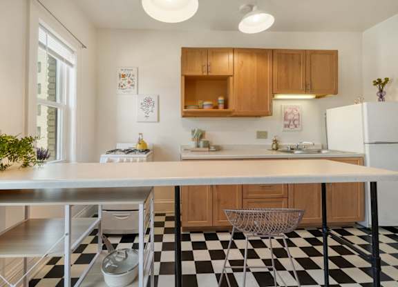 A kitchen with a black and white checkered floor.