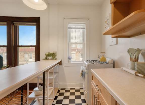 A kitchen with a black and white checkered floor.