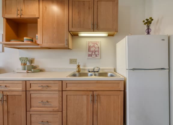 a kitchen with wooden cabinets and a white refrigerator