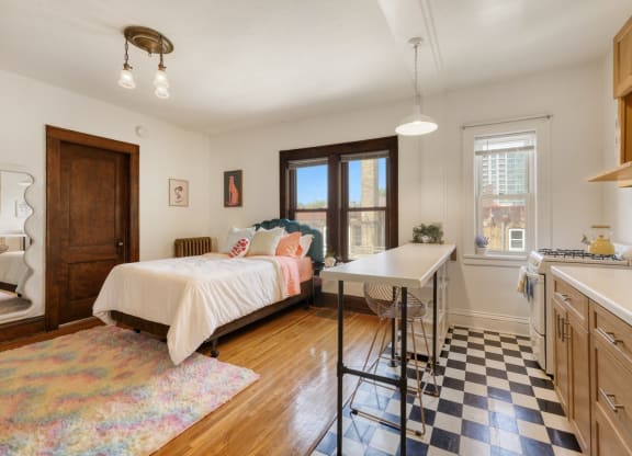 a bedroom with a bed and a desk with a chair