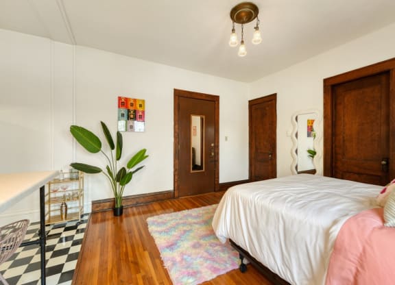 a bedroom with a bed and a desk
