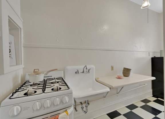 A white stove with a white oven in a kitchen.