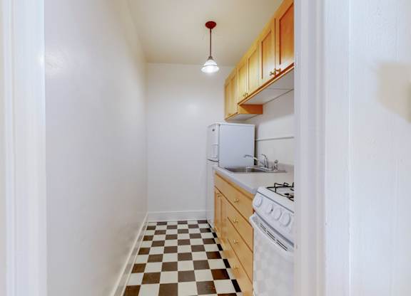 A small kitchen with a checkered floor.