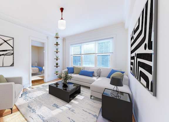 A living room with a couch, a coffee table, and a large abstract painting on the wall.