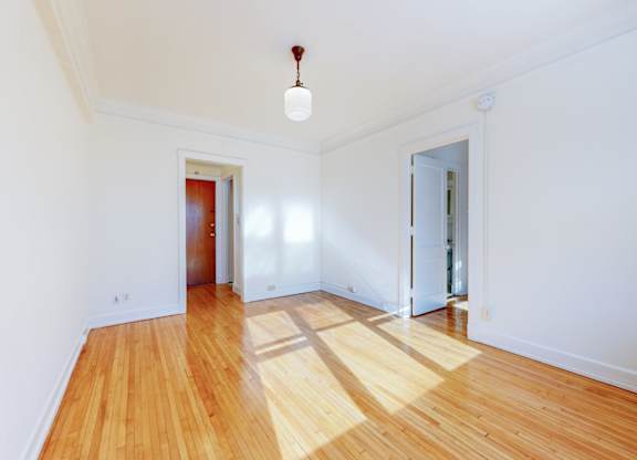A room with wooden floors and white walls.